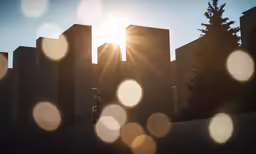 a sun over a city, with lots of buildings