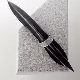 a pen sitting on top of a piece of paper