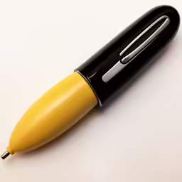 a pen with a yellow top is on the table