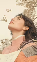 a woman with brown hair is standing outside in the sun