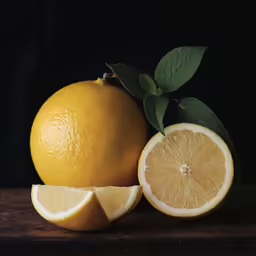 two lemons with slices cut off on a table