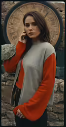 a woman standing and talking on a cell phone