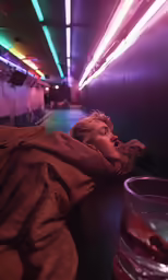 a woman lying down on the floor in front of a glass