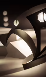 a modern sculpture has three lights on each side of it