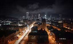 the city is illuminated by headlights and clouds