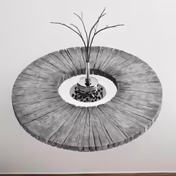 a gray vase with a plant inside on top of a wooden table