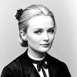 a woman is posing in a black suit