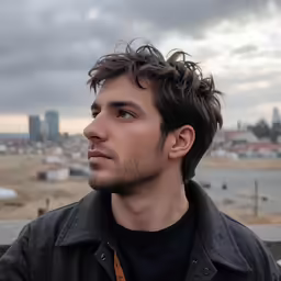 a man with a beard is staring at the sky