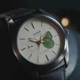an antique wrist watch is sitting on a table