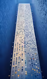 an upward view of a skyscraper and street