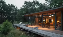 a small house in the woods with glass walls