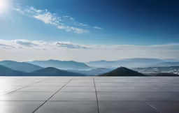 sun is shining over a view of a mountain range