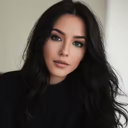 a beautiful asian woman with dark hair posing for a picture