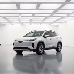 the white suv is parked in the white room