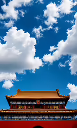 the view of a tall building and a cloudy blue sky
