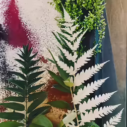 green leaves and flowers are arranged together in an image