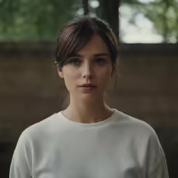a close up of a woman with hair in an updo