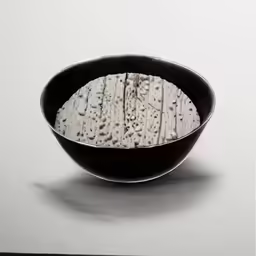 a bowl full of white cheese on a white background