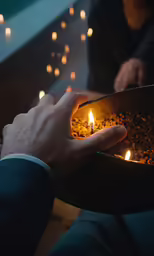 a person is holding a metal container full of lights