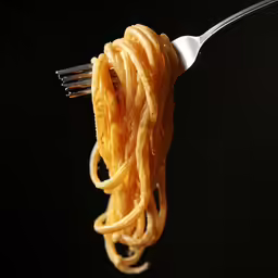fork with food, against black background, indicating something over there