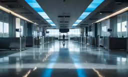 the empty room with some doors and blue ceiling lights