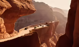 vehicles on the side of a mountain in the middle of the desert