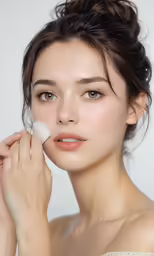 an asian woman putting a white powder on her cheek