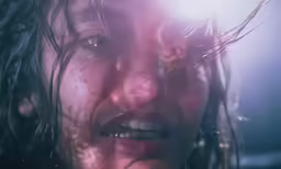 a woman with wet hair holding her hand out to the side