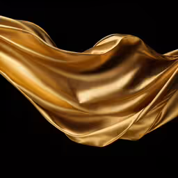 gold cloth flying in the wind on a black background