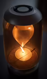 a small hourglass light sitting on top of a table