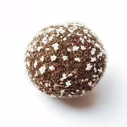 a brown and white ball is laying on a table