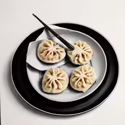 a plate with four dumplings and chopsticks