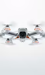 a large white, grey and orange - colored airplane flying through the air