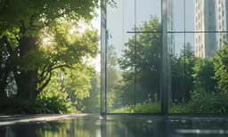 a mirrored entrance in the middle of a park with trees