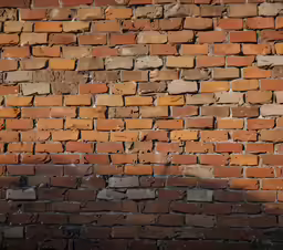 a stop sign in front of a brick wall