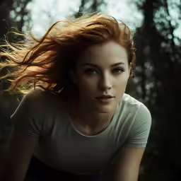 a woman with long hair walking in the woods