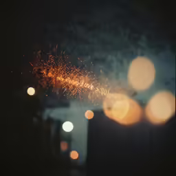 firework in the sky near several lights