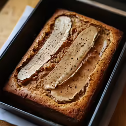 a loaf of bread with something white on it