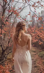 a woman is standing in the forest by herself