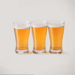 three glasses of beer next to each other