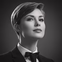 a woman in a tuxedo with a bow tie