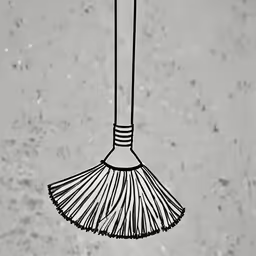 a broom attached to a wall with dirt
