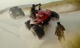 two people riding four wheelers on a dirt road