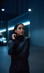 a woman is posing in a black leather outfit