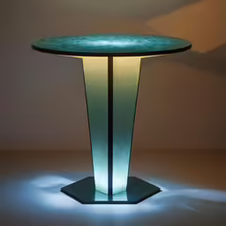 a glass table with a small illuminated base and light on top