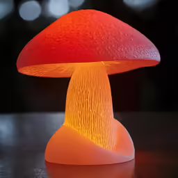 the small orange lit mushroom is sitting on top of a table