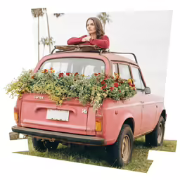 woman standing on the roof of a red vehicle