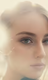 a woman with a long hair and blue eyes stares into the camera