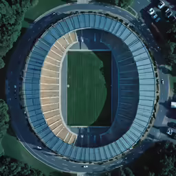 a stadium filled with lots of seats surrounded by trees