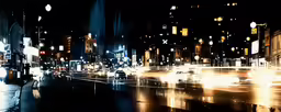 a city street filled with traffic at night